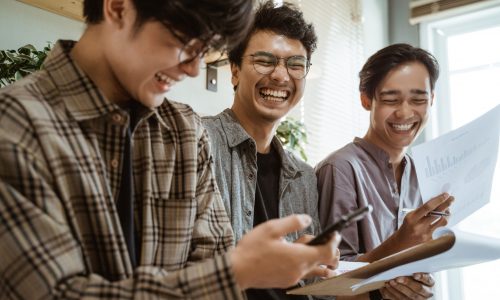 three young asian worker chatting about their product at work